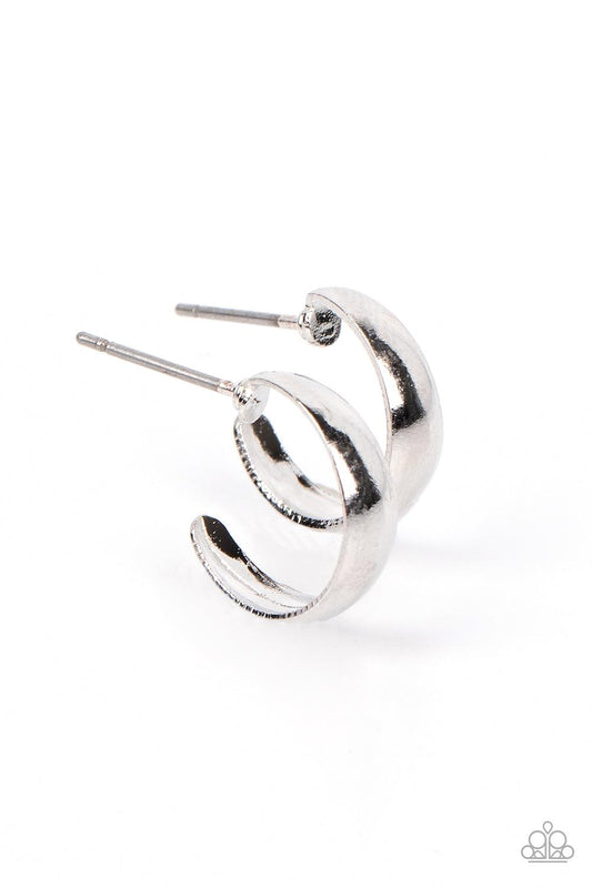 Paparazzi Accessories Mini Magic - Silver Featuring a high-sheen, a slightly flared smooth silver bar curves into a dainty hoop resulting in a basic staple piece perfect for layering. Earring attaches to a standard post fitting. Hoop measures approximatel