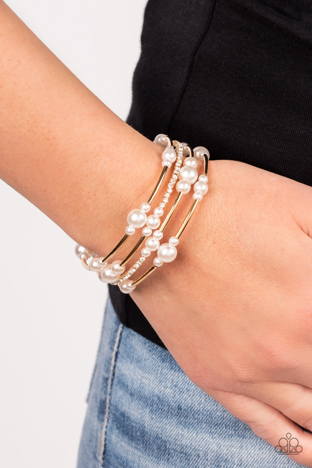 Paparazzi Accessories Marina Masterpiece - Gold Bubbly white pearls, cylindrical gold beads, and glassy white rhinestones are threaded along a coiled wire, resulting in a timeless infinity wrap bracelet around the wrist. Sold as one individual bracelet. J