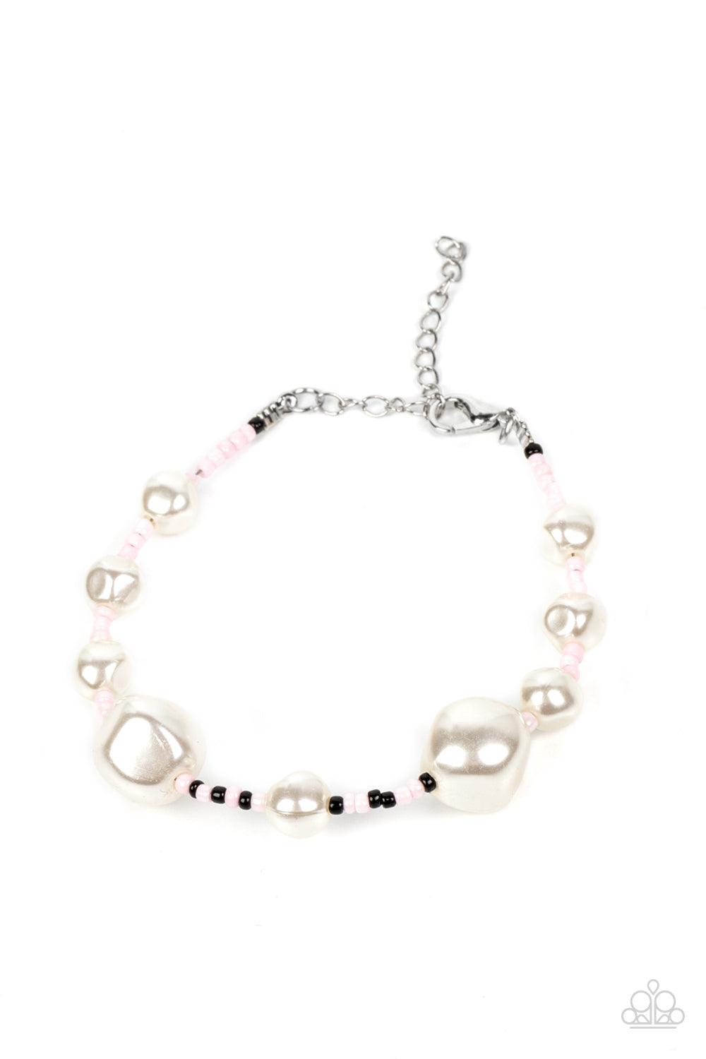 Paparazzi Accessories Contemporary Coastline - Pink Irregular-shaped pearls in varying sizes are scattered amongst Gossamer Pink, black, and silvery seed beads that are threaded along a wire, resulting in a refreshing and playful style around the wrist. F