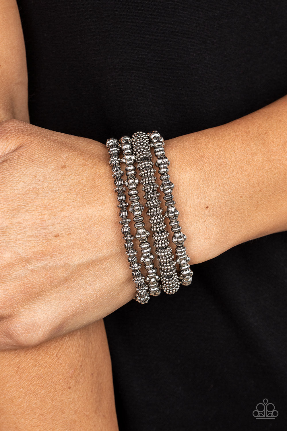 Paparazzi Accessories Country Charmer - Silver An antiqued assortment of studded, round, and decorative silver beads are threaded along stretchy bands around the wrist, creating rustic layers. Sold as one set of four bracelets. Bracelets