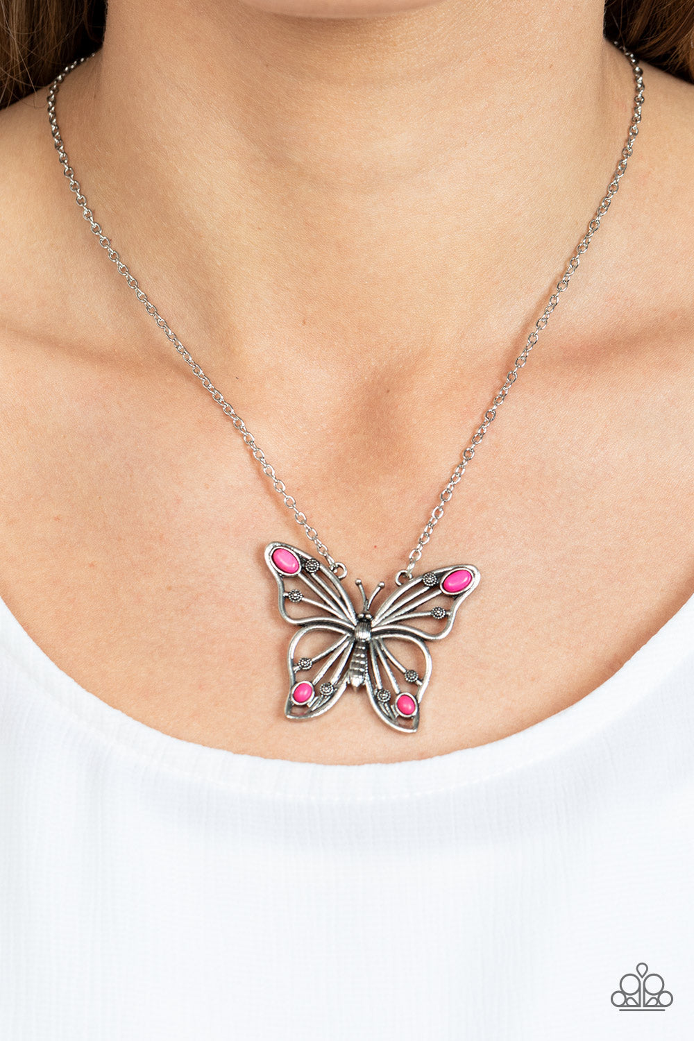 Paparazzi Accessories Badlands Butterfly - Pink Accented in oval pink stones, a decorative silver butterfly flutters at the bottom of a lengthened silver chain for a free-spirited finish. Features an adjustable clasp closure. Sold as one individual neckla