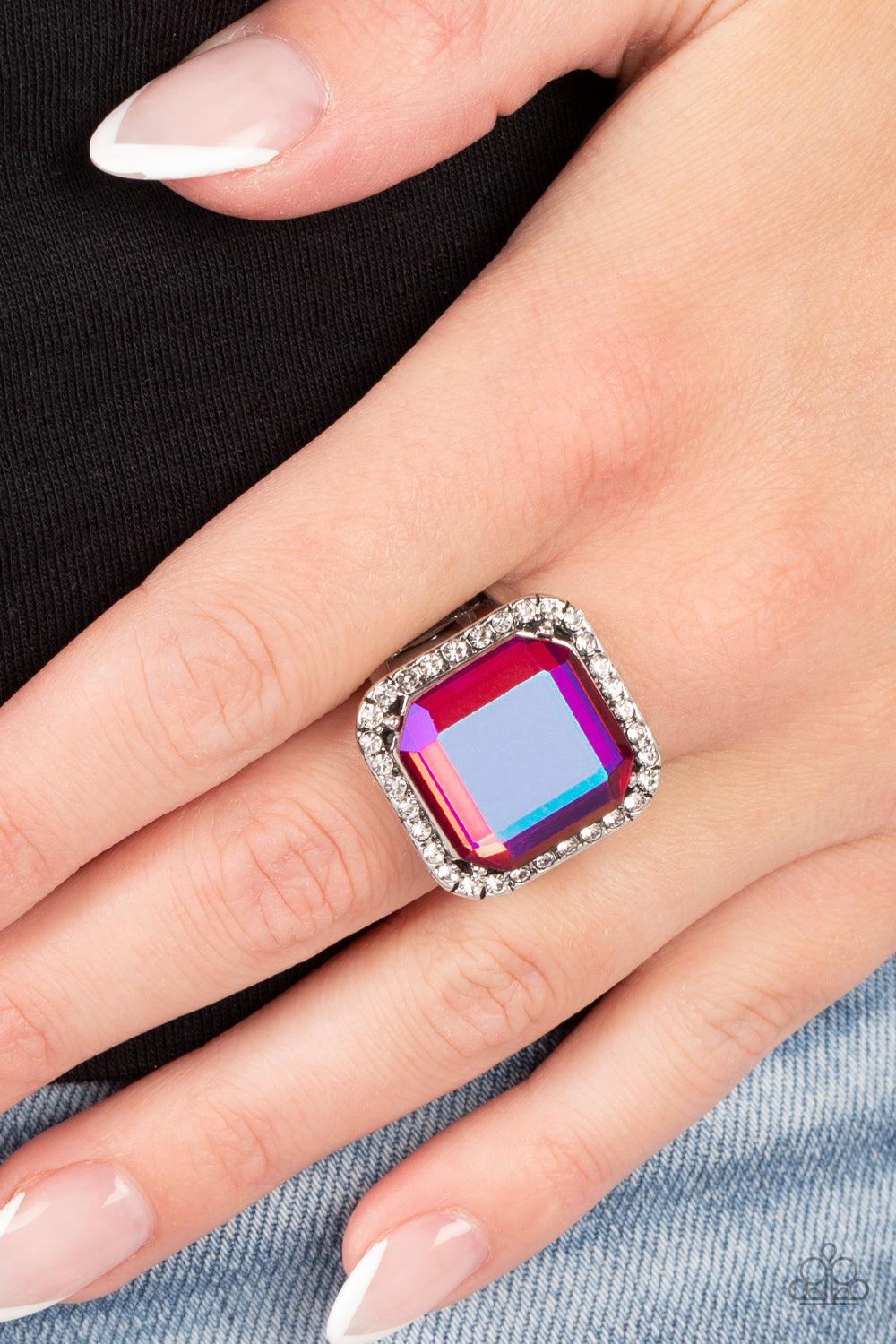 Paparazzi Accessories Slow Burn - Pink A lavish square iridescent pink gem, encased in a border of dainty white rhinestones, makes a head-turning centerpiece as it gleams with an industrial edge atop the finger. Features a stretchy band for a flexible fit