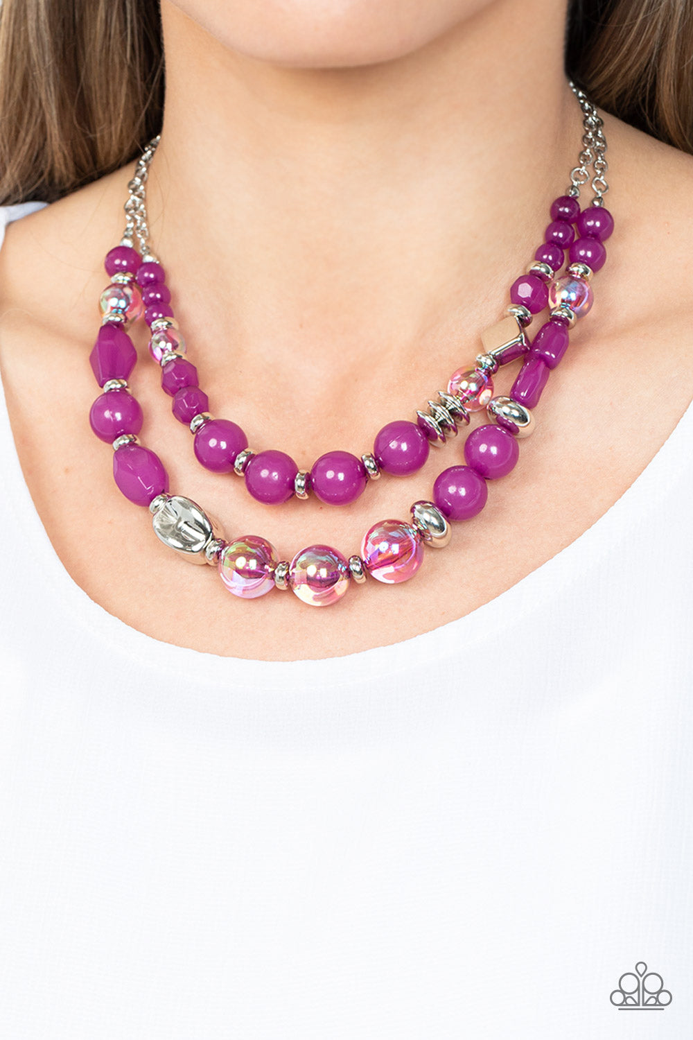 Paparazzi Accessories Mere Magic - Purple Featuring various shapes and finishes, a mismatched assortment of silver, iridescent, and opaque Dahlia beads have been threaded along invisible wires below the collar, creating ethereal layers. Features an adjust