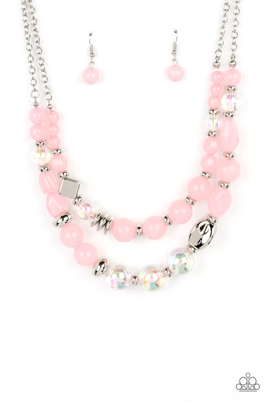 Paparazzi Accessories Mere Magic - Pink Featuring various shapes and finishes, a mismatched assortment of silver, iridescent, and opaque Gossamer Pink beads have been threaded along invisible wires below the collar, creating ethereal layers. Features an a