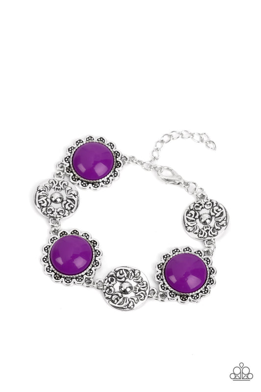 Paparazzi Accessories Positively Poppy - Purple Shiny oversized Dahlia beads are wrapped in floral-inspired frames of silver, filled with studded texture. Silver discs embossed in a filigree motif alternate with the vibrant beads as they link around the w