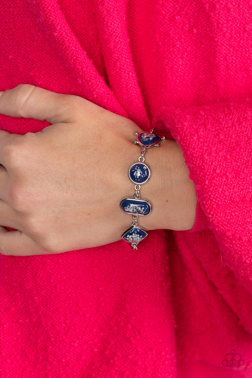 Paparazzi Accessories Speckled Shimmer - Blue Glassy blue beads speckled in flecks of silver shimmer delicately connect around the wrist in a glitzy geometric display. Features an adjustable clasp closure. Sold as one individual bracelet. Get The Complete