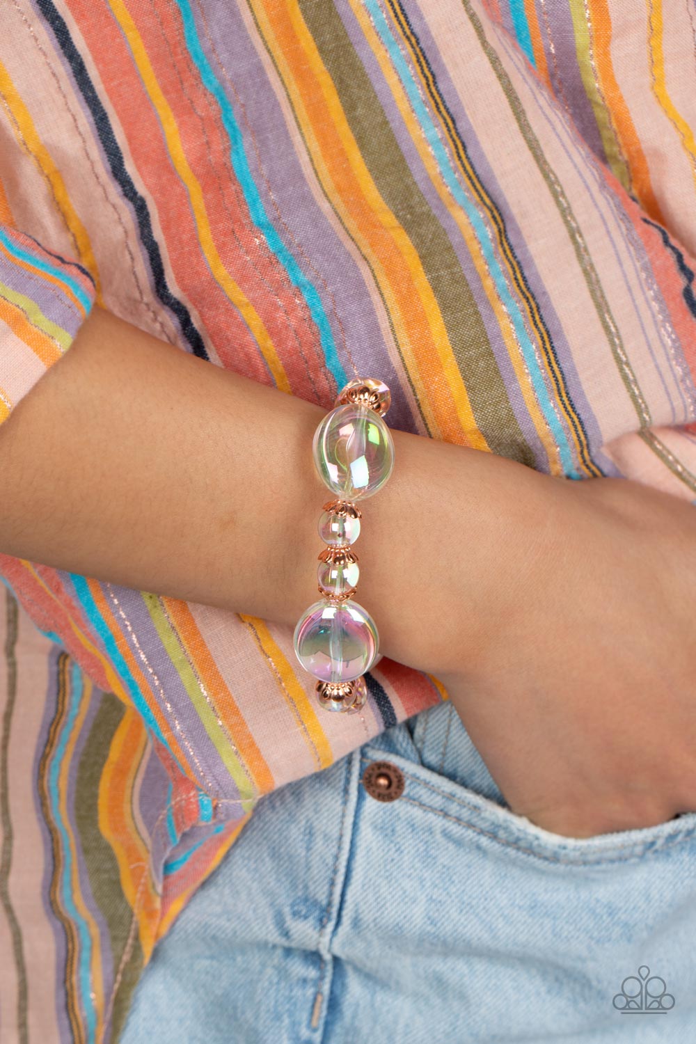 Paparazzi Accessories Iridescent Illusions - Copper Bubbly iridescent beads in varying sizes are threaded along a stretchy band, creating a glittery magical effect around the wrist. Shiny copper cap fittings encase the smaller beads, adding vintage metall