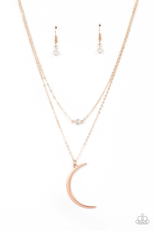 Paparazzi Accessories Modern Moonbeam - Rose Gold Two dainty rose gold chains delicately layer below the collar. A white crystal-like bead sparkles at the center of the uppermost chain while a rose gold half moon pendant swings from the bottom of the disp