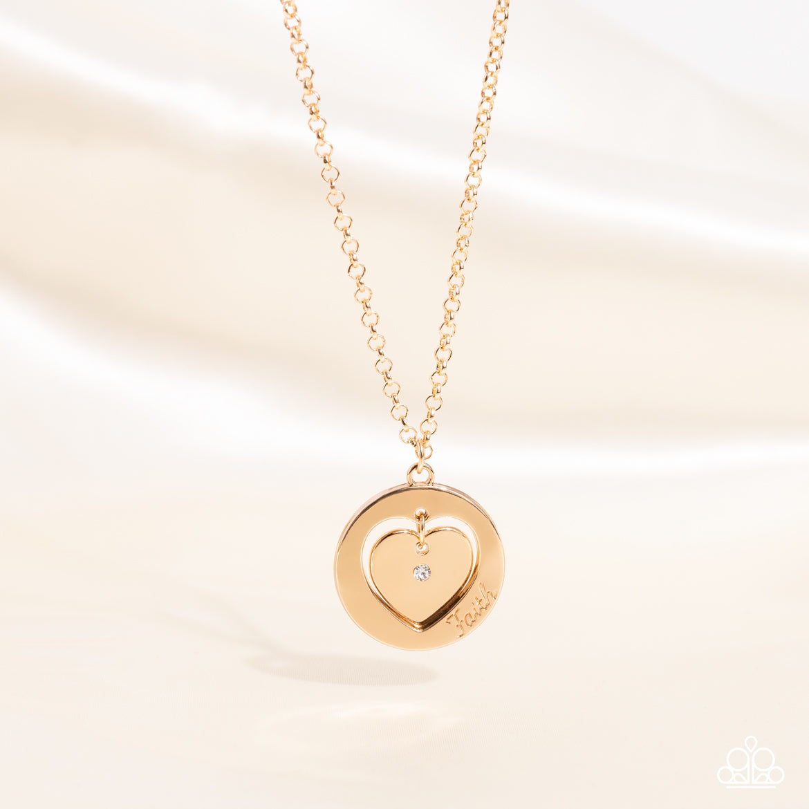 Paparazzi Accessories Heart Full of Faith - Gold Dotted with a dainty white rhinestone, a gold heart charm swings freely inside of a heart-cutout gold frame. Stamped in the word, "Faith," the inspirational pendant falls just below the collar for a sentime