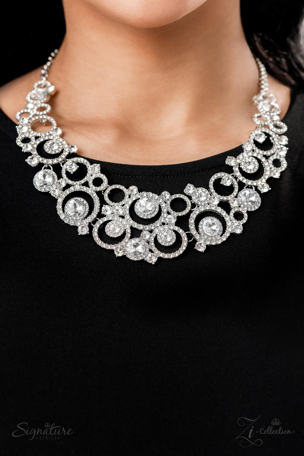 Paparazzi Accessories The Jennifer Dozens of circular silver frames are encrusted in shimmery white rhinestones and link together to create a dizzying display along the collar. The frames gradually increase in size as they lead to the center, boldly showc