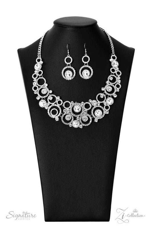 Paparazzi Accessories The Jennifer Dozens of circular silver frames are encrusted in shimmery white rhinestones and link together to create a dizzying display along the collar. The frames gradually increase in size as they lead to the center, boldly showc