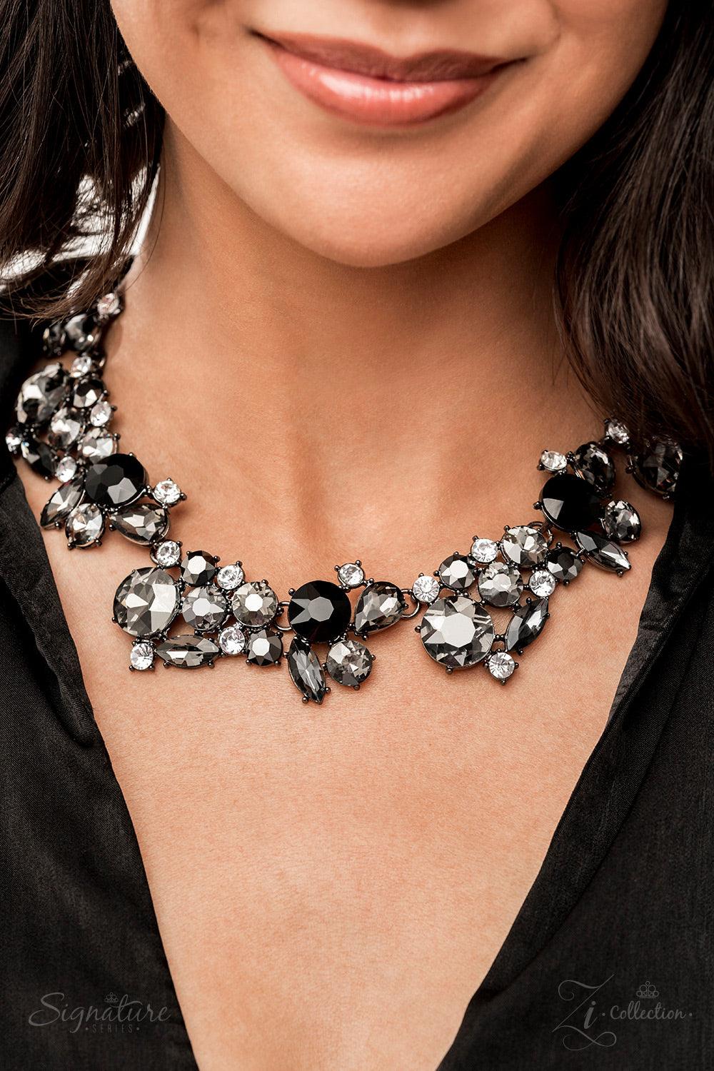 Paparazzi Accessories The Kim A smoldering explosion of smoky gray, jet black, and sparkling white rhinestones gather into haphazard clusters that link fearlessly along the collar. The faceted edges of each round, marquise, and teardrop cut gem scatter li