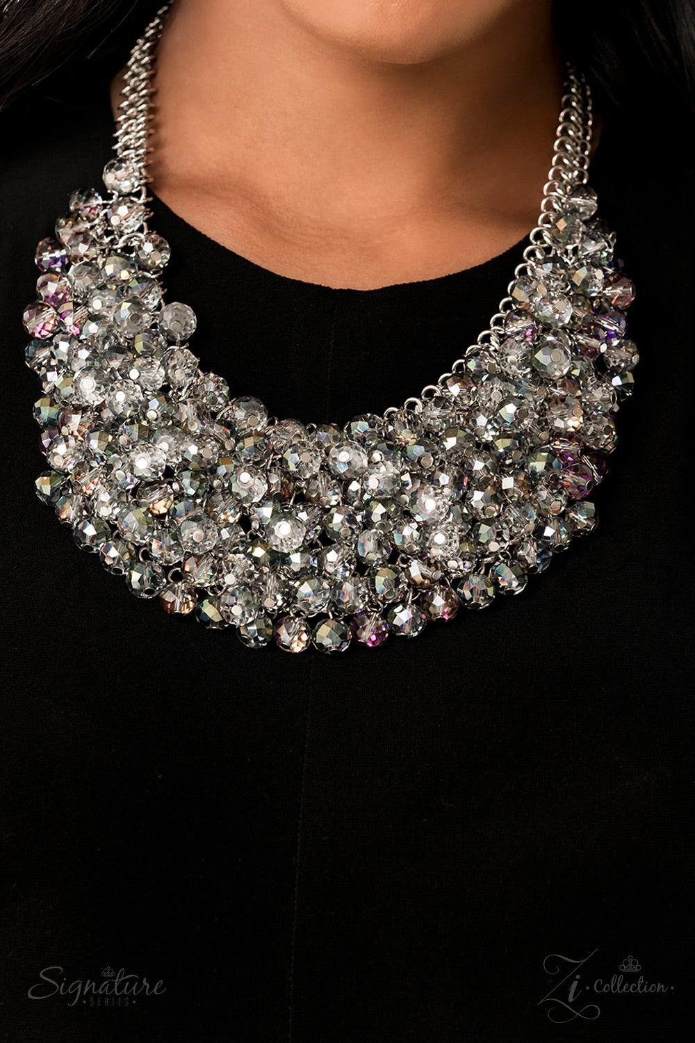 Paparazzi Accessories The Tanger Countless clear, crystal-like beads connect to a netted backdrop of interlocking silver links, building into a boisterous display of glassy elegance. Each faceted edge of the beads is brushed in a dreamily iridescent or hy