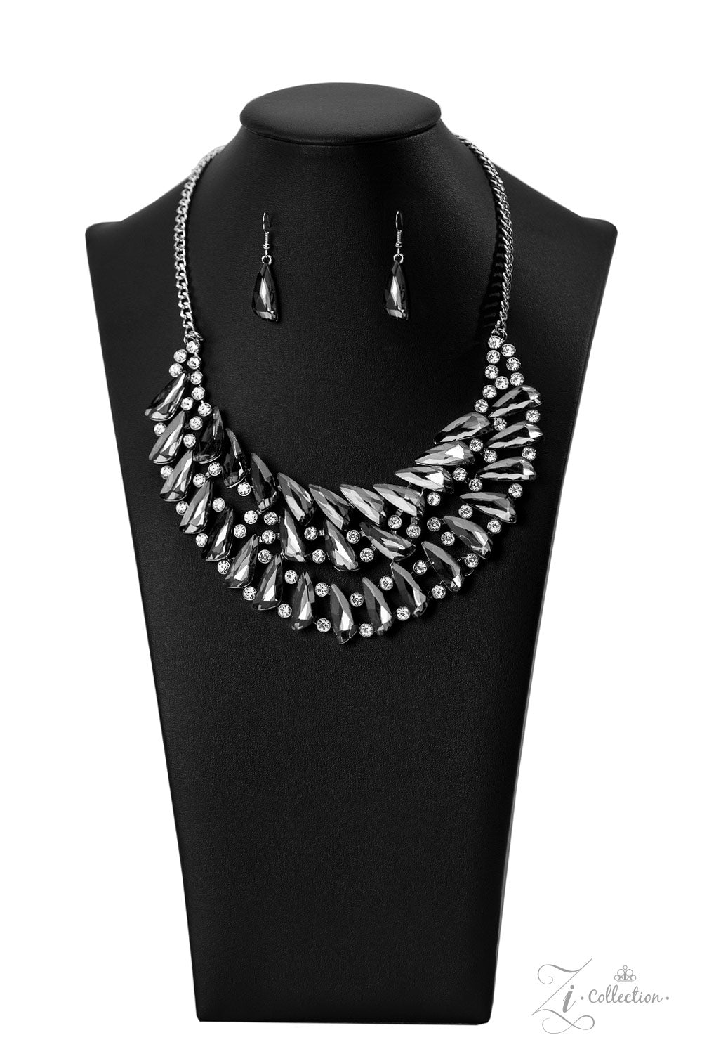 Paparazzi Accessories Perceptive Smoky, triangular rhinestones are scattered along the collar in razor-sharp precision, falling into a dramatic, angular pattern. Brilliant white rhinestones are sprinkled in between the faceted, smoldering gems, adding fea