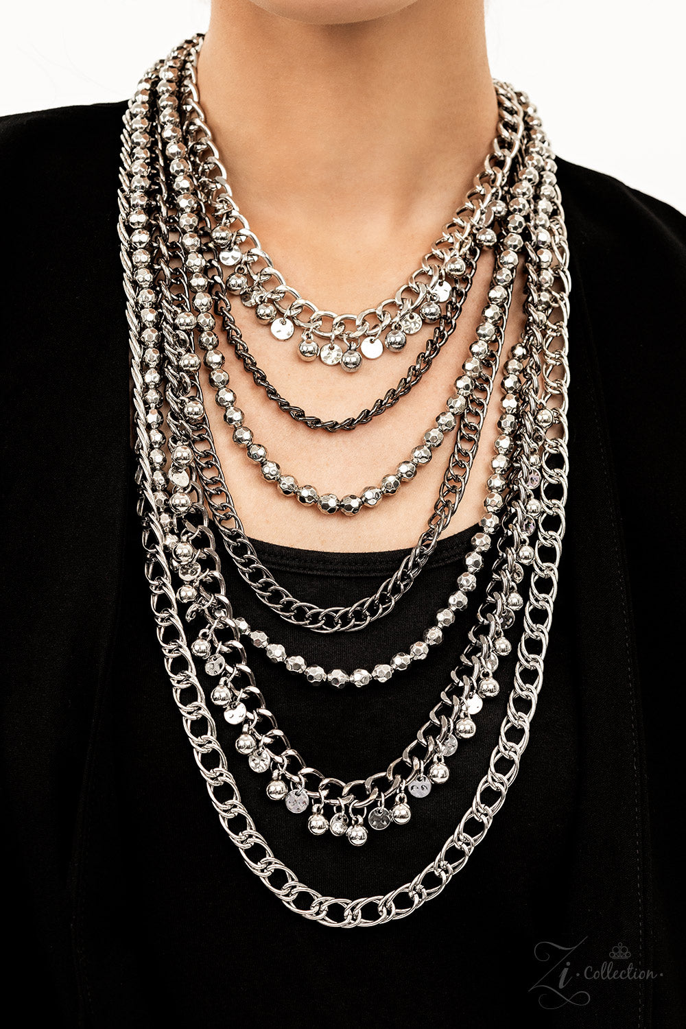 Paparazzi Accessories Audacious Featuring a range of oval and curb style links, a chaotic assortment of bulky silver and gunmetal chains fearlessly layers down the chest. Polished silver beads and textured silver discs swing from the thick curb chains, in