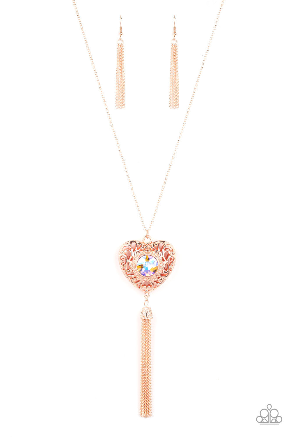 Paparazzi Accessories Prismatic Passion - Gold A magical iridescent peach gem sparkles at the center of a 3-dimensional rose gold heart. Filled with vine-like filigree, the locket inspired heart frame glides along an extended rose gold chain while a shimm