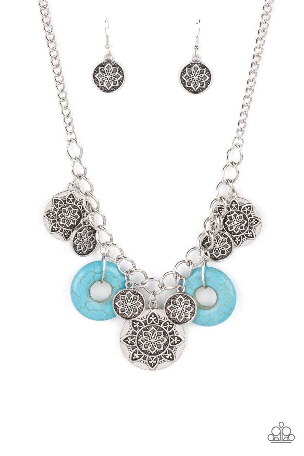 Paparazzi Accessories Western Zen - Blue A collection of silver discs, embellished with intricate mandala-like designs, dances along a thick silver chain, with a pair of polished turquoise stone rings adding a pop of color to the rustic design. Features a