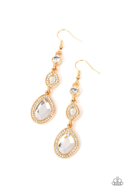 Paparazzi Accessories Dripping Self-Confidence - Gold Bordered in gold frames dotted with tiny flecks of white rhinestones, a pair of asymmetrical white gems delicately link into a spellbinding sparkle around the ear. Earring attaches to a standard fishho