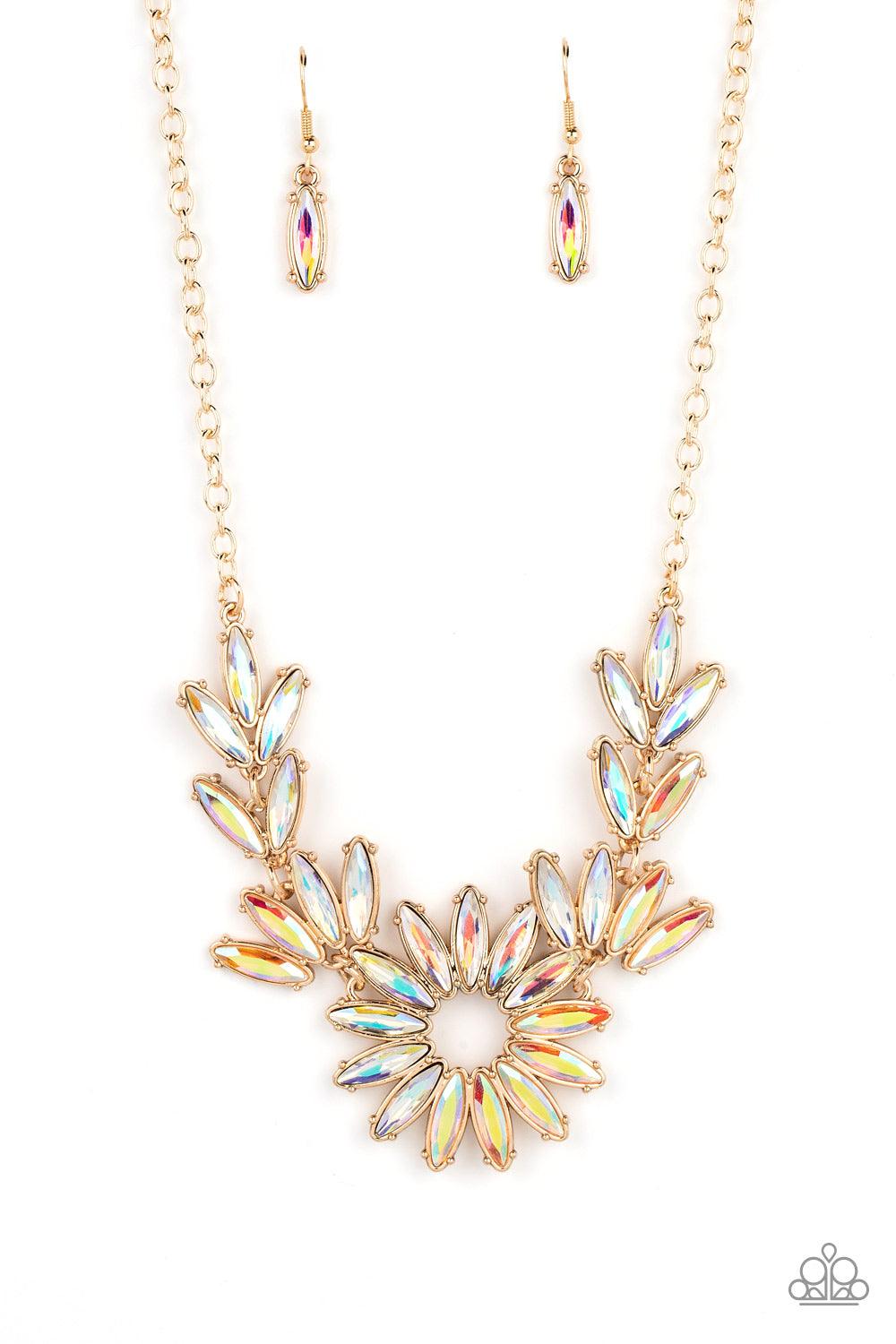 Paparazzi Accessories Celestial Cruise - Gold Featuring oblong marquise cuts, a collection of iridescent gems join into leafy gold frames below the collar. Radiating with the same iridescent intensity, even more stellar rhinestones fan out into a circular