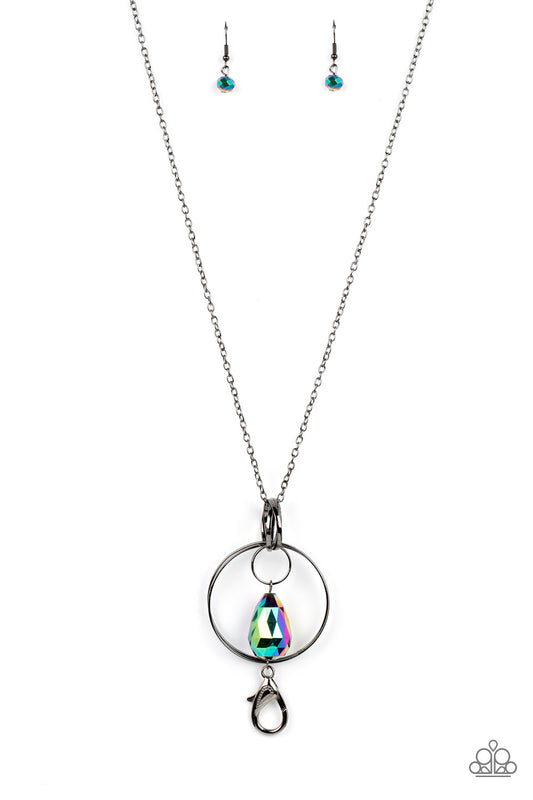Paparazzi Accessories Swinging Shimmer - Multi *Lanyard Featuring an oversized faceted teardrop coated in a reflective oil spill finish, the teardrop swings from a mismatched collection of interconnected gunmetal rings at the bottom of an extended gunmeta