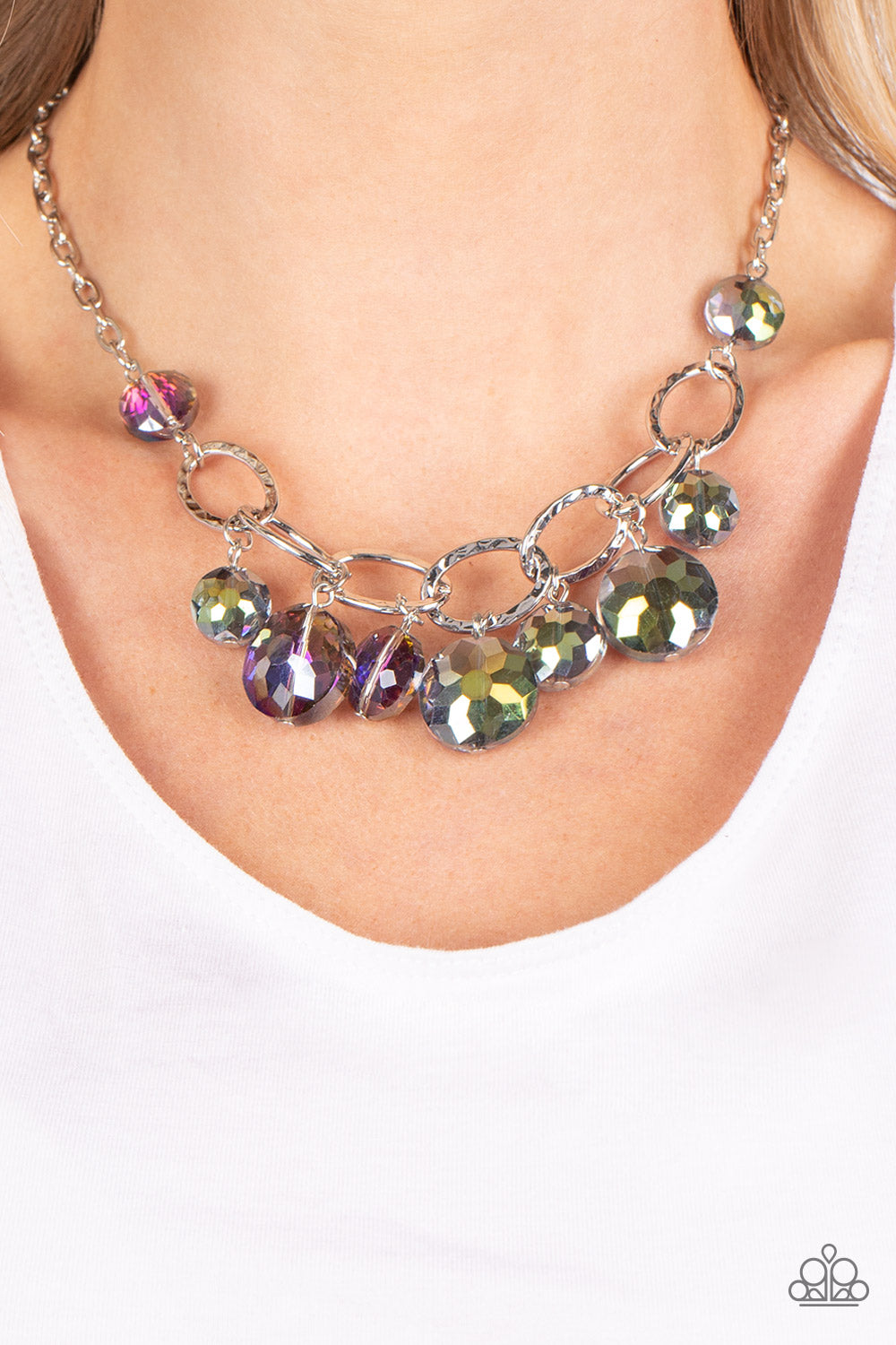 Paparazzi Accessories Rhinestone River - Multi A collection of round, glassy purple-shaded beads in varying sizes swirl around shiny silver oval links hammered in texture. The beveled shape and faceted surfaces of the beads are brushed in a subtle oil-spi