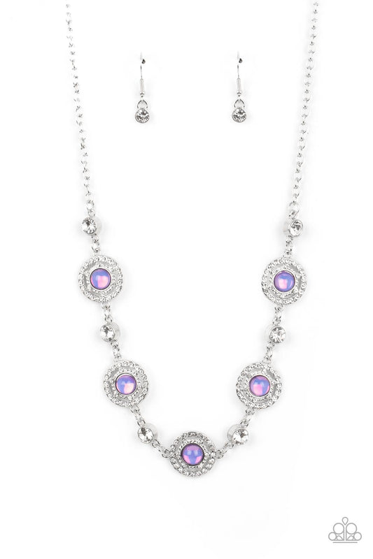 Paparazzi Accessories Summer Dream - Purple Solitaire white rhinestones alternate with rippling circular frames of silver dusted in dainty white rhinestones, creating an enchanting statement piece. Featured in the center of the scintillating frames, glass