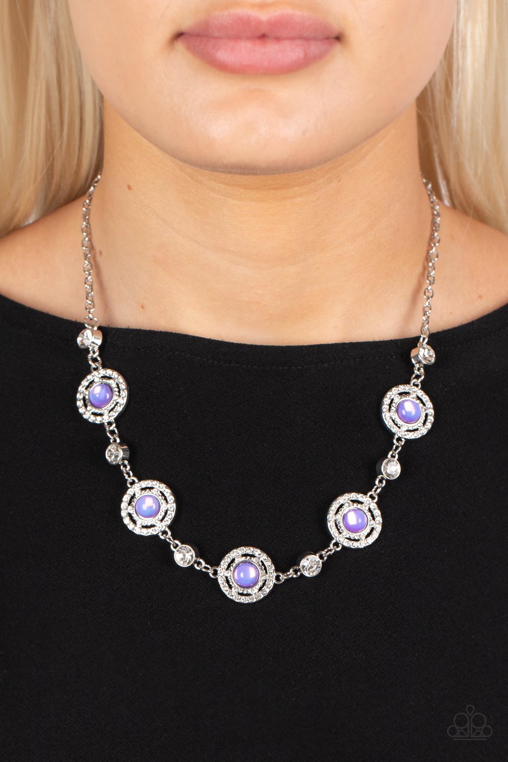 Paparazzi Accessories Summer Dream - Purple Solitaire white rhinestones alternate with rippling circular frames of silver dusted in dainty white rhinestones, creating an enchanting statement piece. Featured in the center of the scintillating frames, glass