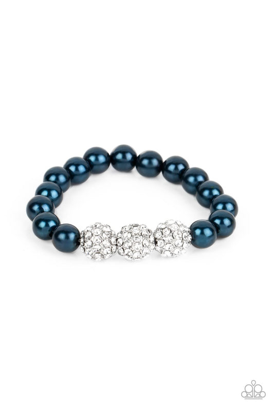 Paparazzi Accessories Breathtaking Ball - Blue A trio of silver beads encrusted in rhinestones is centered along a strand of classic Montanna pearls. The beads are threaded along a stretchy band, wrapping around the wrist in a refined finish. Sold as one