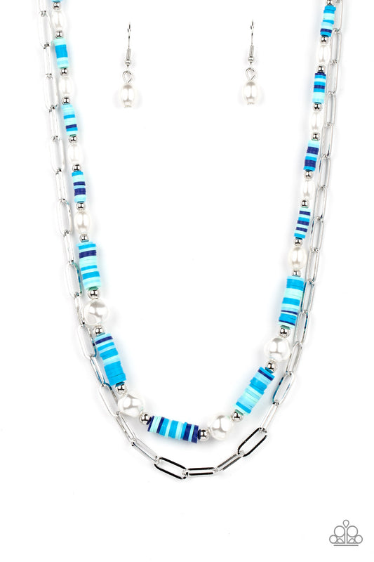 Paparazzi Accessories Tidal Trendsetter - Blue Sections of colorful rubber discs in shades of blue, turquoise, and navy are separated by tiny silver beads and a variety of white baroque pearls to create an unexpected mashup of texture along the collar. A