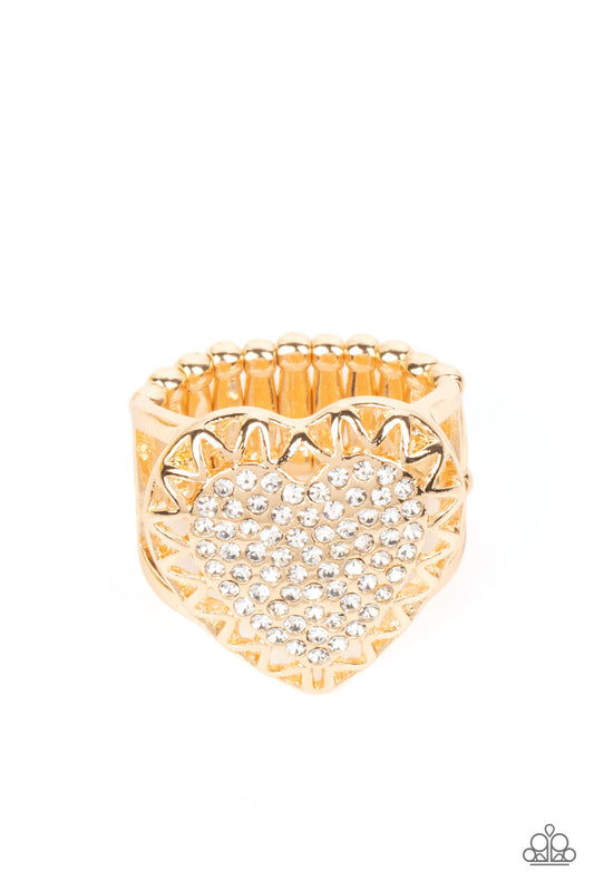 Paparazzi Accessories Romantic Escape - Gold An airy gold frame with cutouts resembling a subtle zig-zag pattern, wraps around a heart filled with brilliant white rhinestones to create a dazzling centerpiece atop the finger. Features a stretchy band for a
