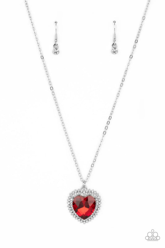 Paparazzi Accessories Sweethearts Stroll - Red A red crystal-like heart gem sparkles dramatically as it's wrapped in a glassy white rhinestone-studded heart frame. Adding additional shimmer, a second layer of white rhinestones encircles the studded pendan