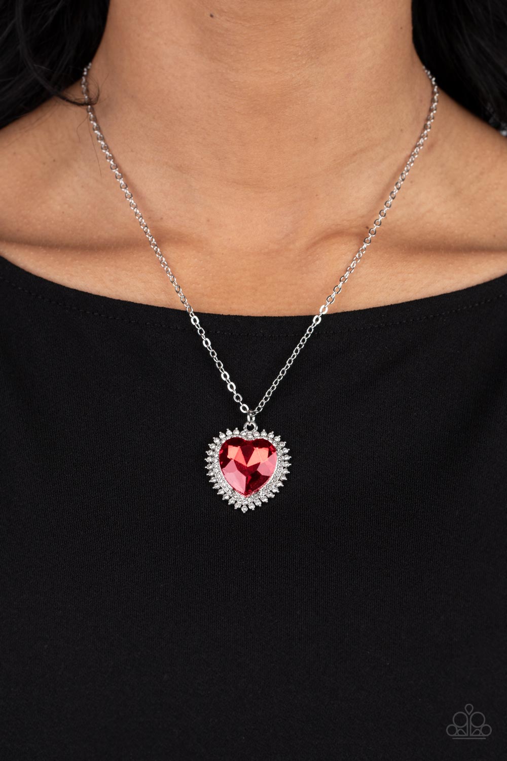 Paparazzi Accessories Sweethearts Stroll - Red A red crystal-like heart gem sparkles dramatically as it's wrapped in a glassy white rhinestone-studded heart frame. Adding additional shimmer, a second layer of white rhinestones encircles the studded pendan