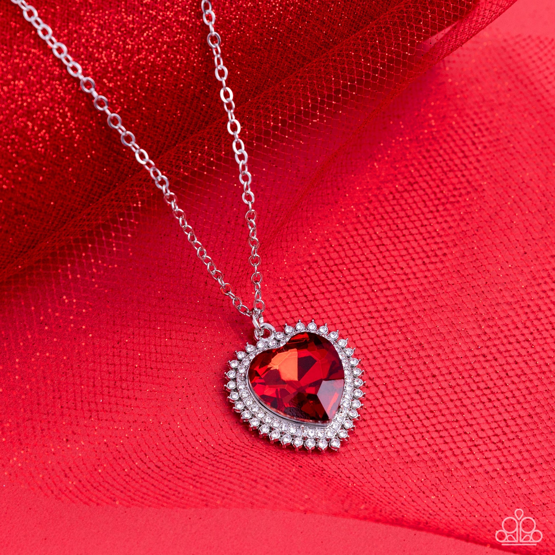 Paparazzi Accessories Sweethearts Stroll - Red A red crystal-like heart gem sparkles dramatically as it's wrapped in a glassy white rhinestone-studded heart frame. Adding additional shimmer, a second layer of white rhinestones encircles the studded pendan