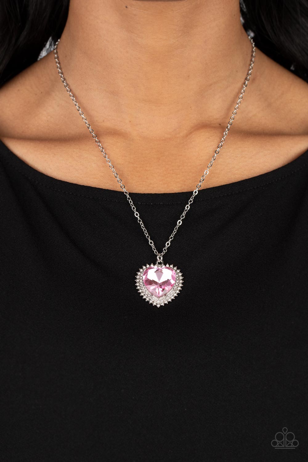 Paparazzi Accessories Sweethearts Stroll - Pink A pink crystal-like heart gem sparkles dramatically as it's wrapped in a glassy white rhinestone-studded heart frame. Adding additional shimmer, a second layer of white rhinestones encircles the studded pend