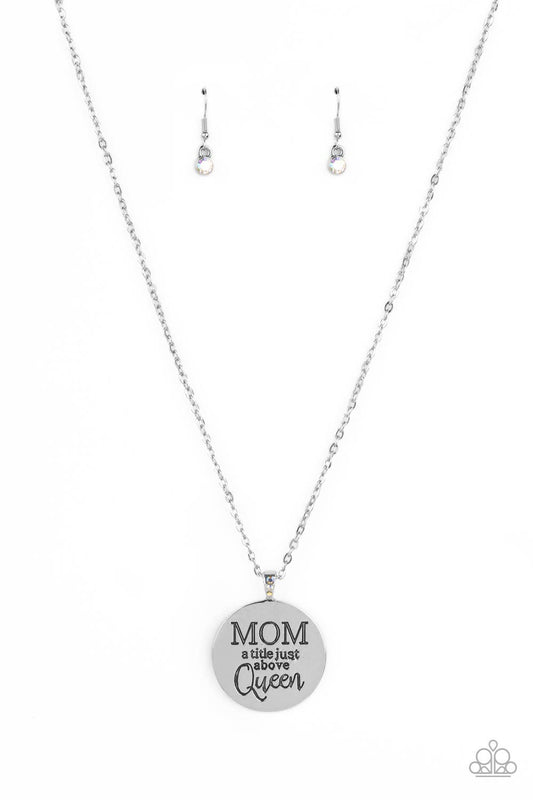 Paparazzi Accessories Mother Dear - Multi At the bottom of a shiny silver chain, a shiny silver disc is stamped with the phrase, "MOM a title just above Queen." The clasp attaching the disc to the chain features a collection of dainty iridescent rhineston