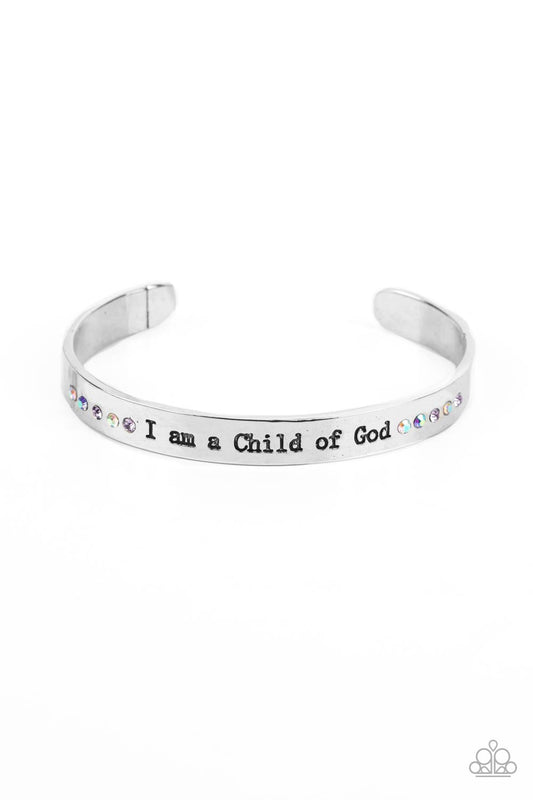 Paparazzi Accessories Divine Display - Multi A shiny silver cuff stamped with the phrase "I am a Child of God" encircles the wrist. Dainty sapphire, violet and iridescent rhinestones shimmer at the borders of the phrase for a whimsical finish. Due to its