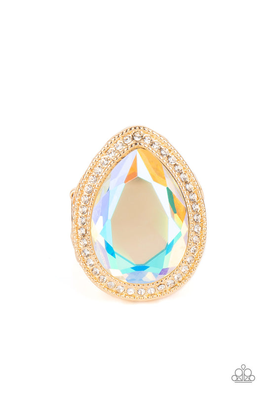 Paparazzi Accessories Illuminated Icon - Gold An oversized teardrop gem with an iridescent finish is nestled inside a gold teardrop frame encrusted in dainty white rhinestones. Airy teardrop cutouts decorate each side of the oversized frame, some with sub