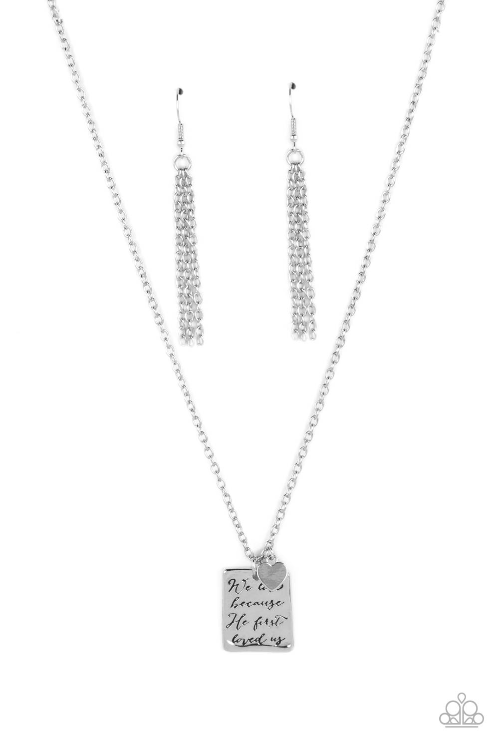 Paparazzi Accessories Divine Devotion - Silver Dangling below a delicate silver chain, a hammered rectangular plate swings for some light-catching movement. The religious phrase "We love because He first loved us" is prominently stamped in the center of t