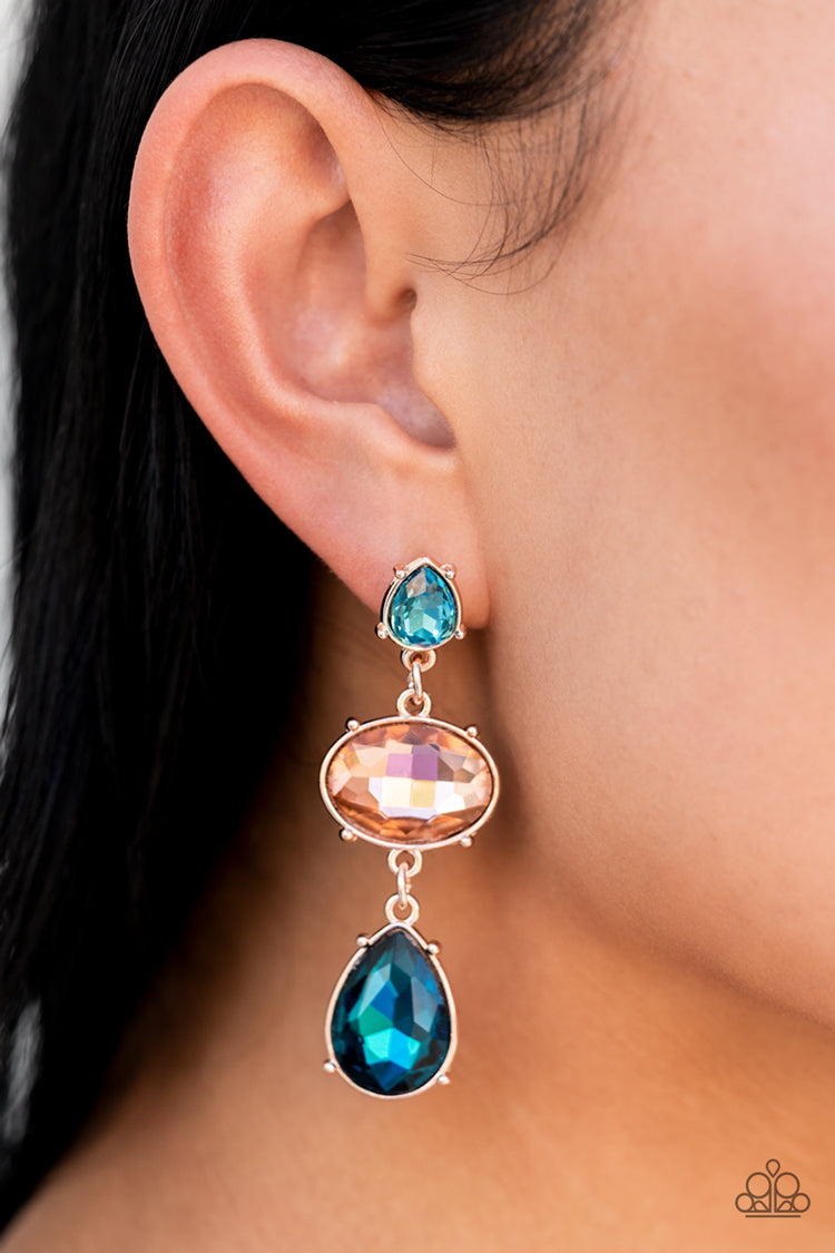 Paparazzi Accessories Royal Appeal - Multi A small, light blue, teardrop-shaped gem gives way to a peachy oval-shaped rhinestone tilted on its side. A large, deep blue teardrop swings from the oval above, adding dramatic movement to the colorful display.