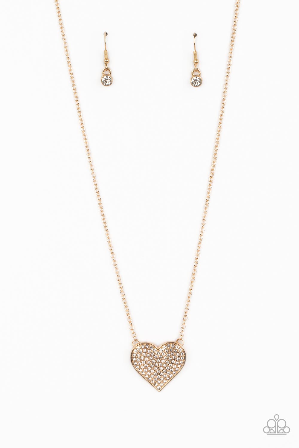 Paparazzi Accessories Spellbinding Sweetheart - Gold A heart-shaped pendant in a gold finish is anchored between two strands of delicate chain in the same reflective finish. The interior of the heart is filled with glittery white rhinestones, inviting onl