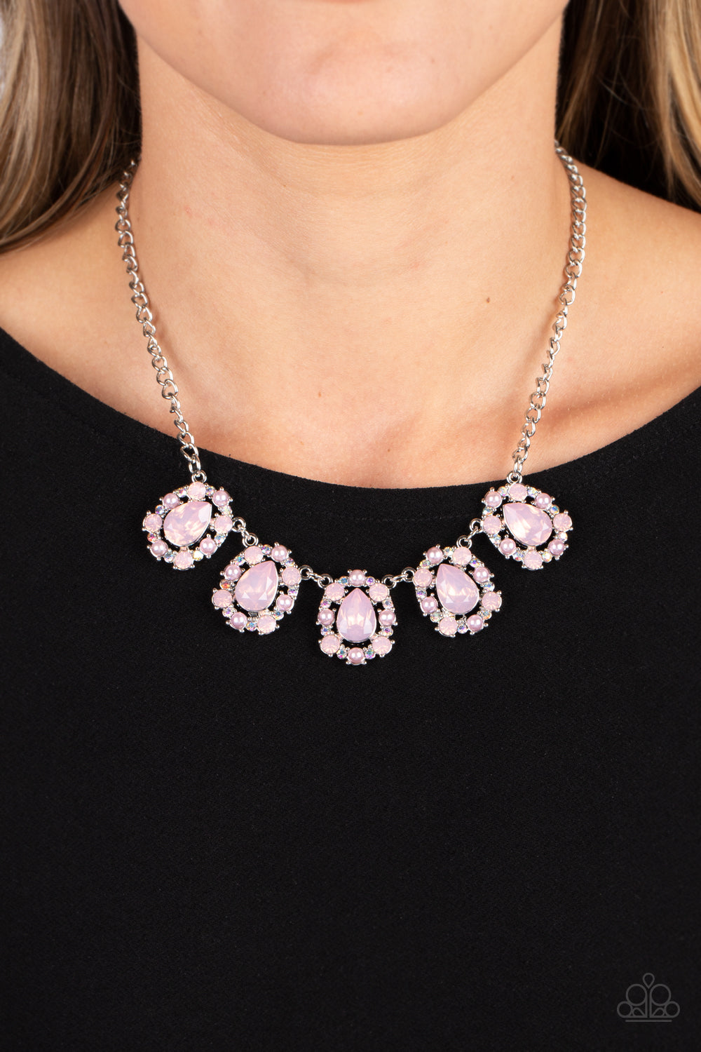 Paparazzi Accessories Pearly Pond - Pink Encased in shimmery silver frames, a collection of pink, opalescent, teardrop gems twinkles above the collar. Dainty pink pearls, pink crystal-like gems, and rhinestones in an iridescent finish surround each teardr