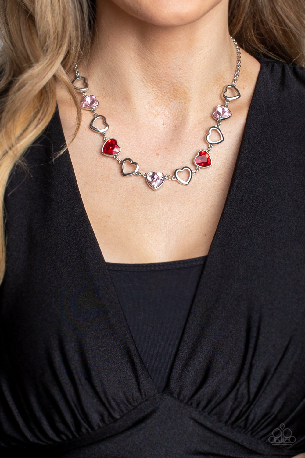 Paparazzi Accessories Contemporary Cupid - Multi Shiny, silver silhouette hearts alternate between faceted red and pink heart gems pressed into silver frames.The high-sheen and sparkly display coalesce around the collar for a cupid-like charm. Features an