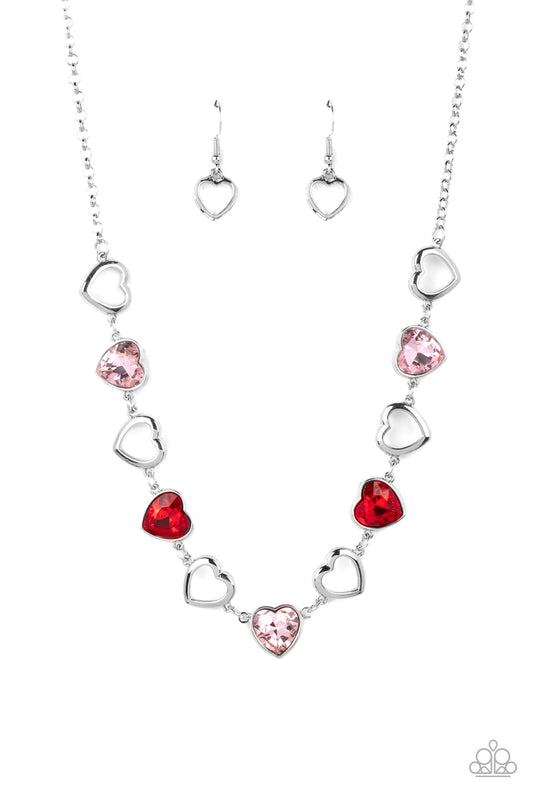 Paparazzi Accessories Contemporary Cupid - Multi Shiny, silver silhouette hearts alternate between faceted red and pink heart gems pressed into silver frames.The high-sheen and sparkly display coalesce around the collar for a cupid-like charm. Features an