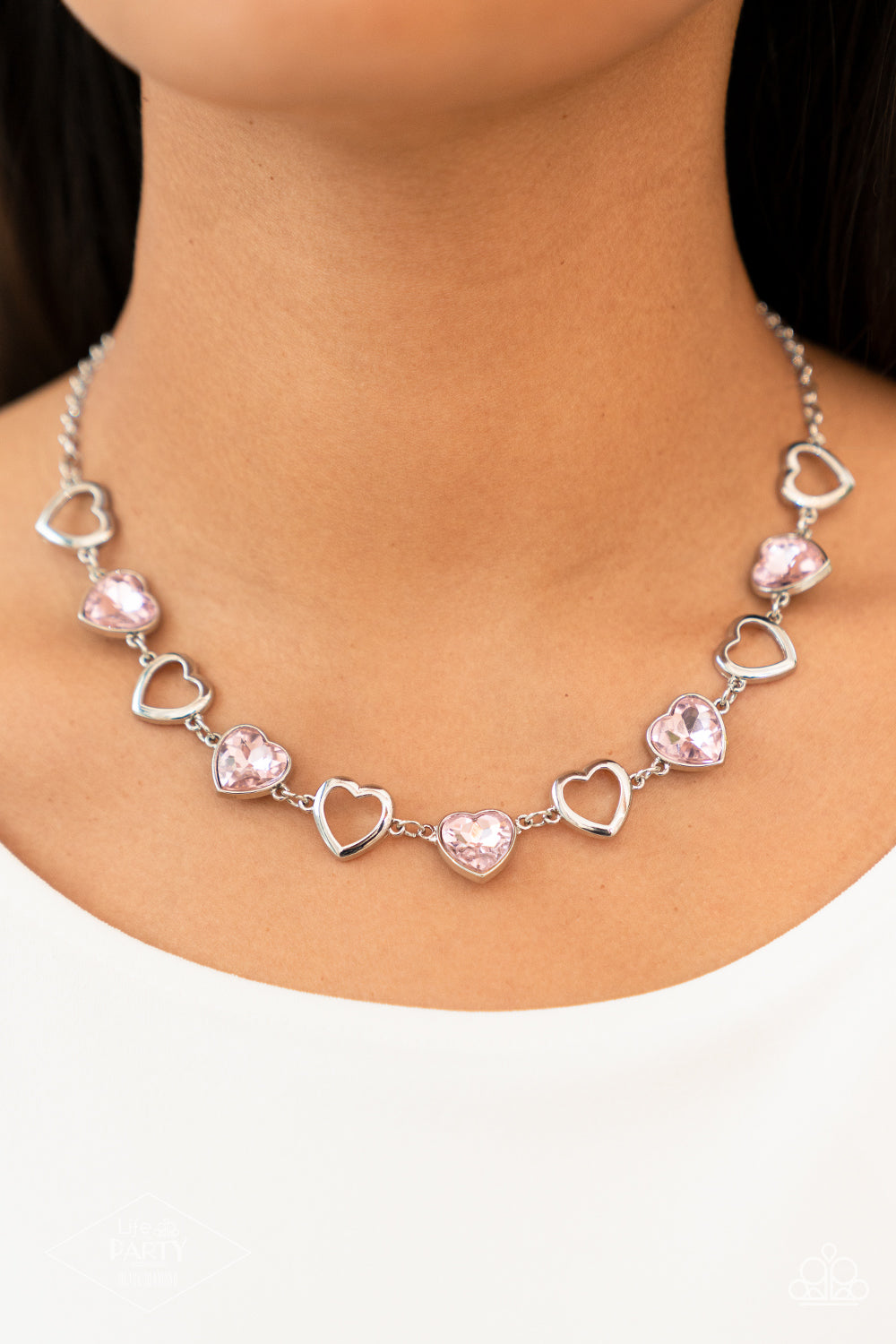 Paparazzi Accessories Contemporary Cupid - Pink Shiny, silver silhouette hearts alternate between faceted pink heart gems pressed into silver frames.The high-sheen and sparkly display coalesce around the collar for a cupid-like charm. Features an adjustab