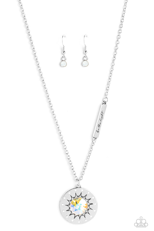 Paparazzi Accessories Sundial Dance - Multi Hanging from the bottom of a classic silver chain, a silver pendant, with a lightly hammered sheen rests. Stamped on the pendant, a sun outlines the center with dainty opalescent rhinestones outlining the shape.