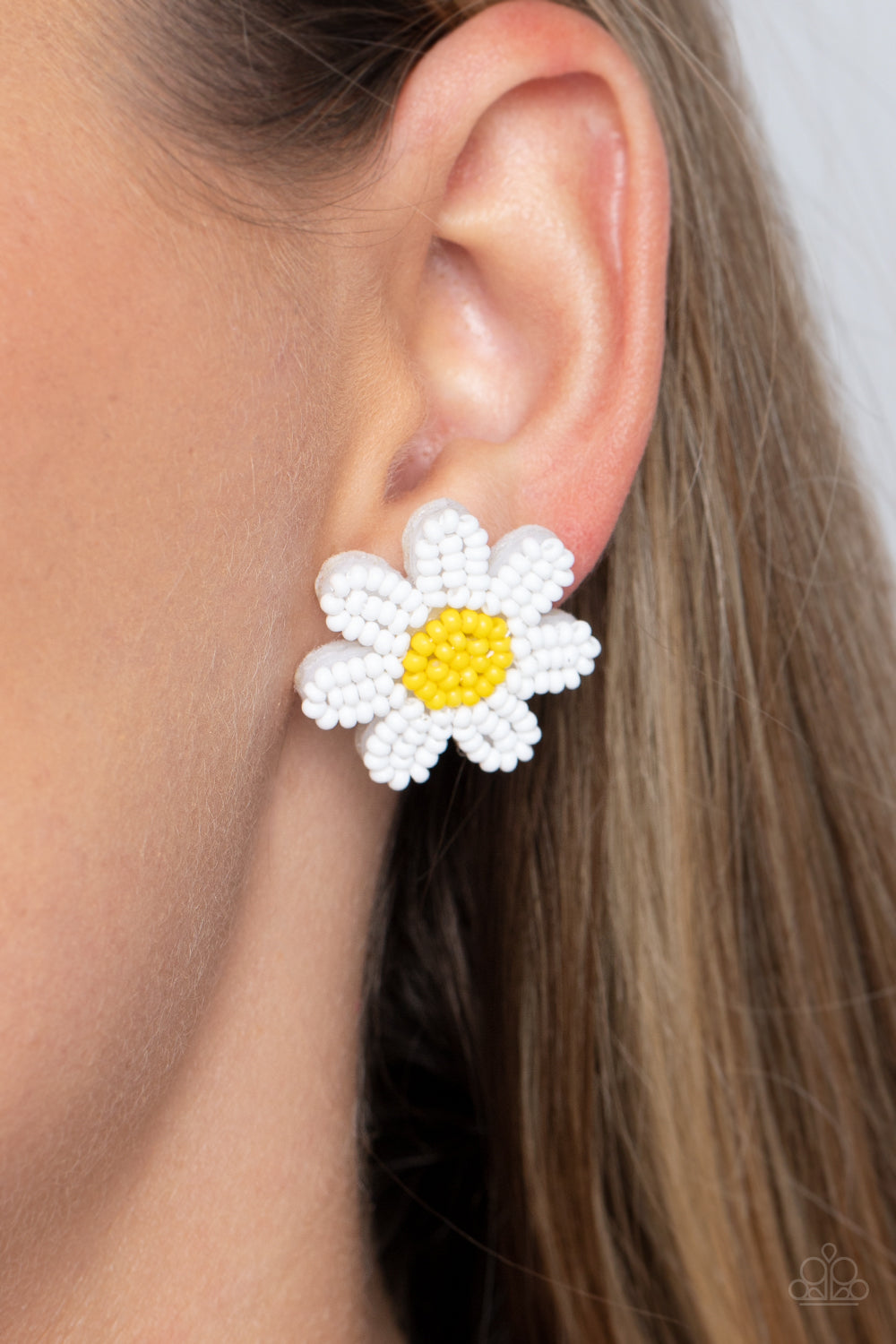 Paparazzi Accessories Sensational Seeds - White Layers of white seed bead petals fan out from a yellow seed bead center, blooming into a textured floral centerpiece. Earring attaches to a standard post fitting. Sold as one pair of post earrings. Jewelry