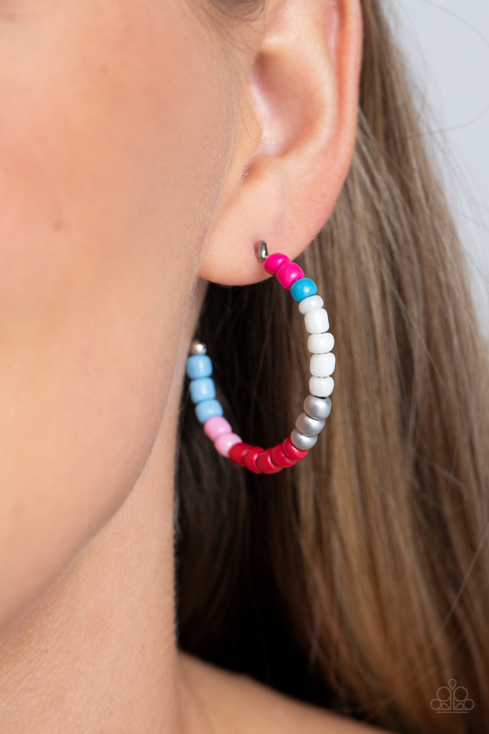 Paparazzi Accessories Multicolored Mambo - Pink Multi A colorful strand of hot pink, blue, white, silver, red, light pink, and baby blue seed beads follow the curve of a silver hoop, creating a colorfully charismatic look. Earring attaches to a standard p