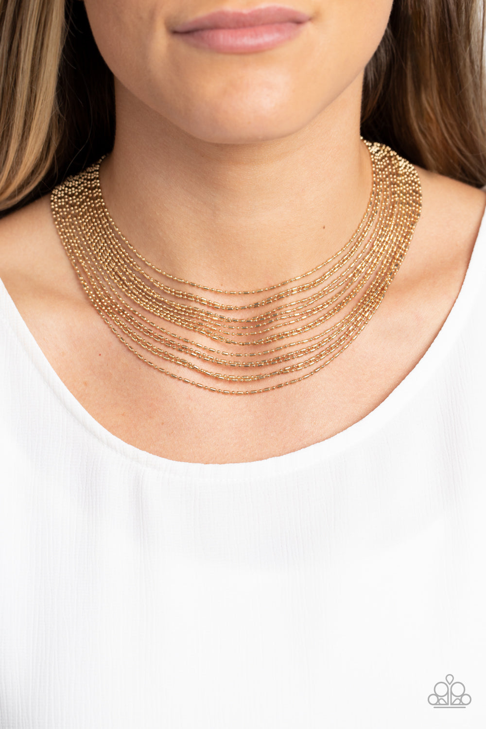 Paparazzi Accessories Cascading Chains - Gold Suspended from two gold, horizontal bars, a shimmery cascade of high-sheen gold ball-and-bar chains layer around the neck for an industrial statement. Features an adjustable clasp closure. Sold as one individu