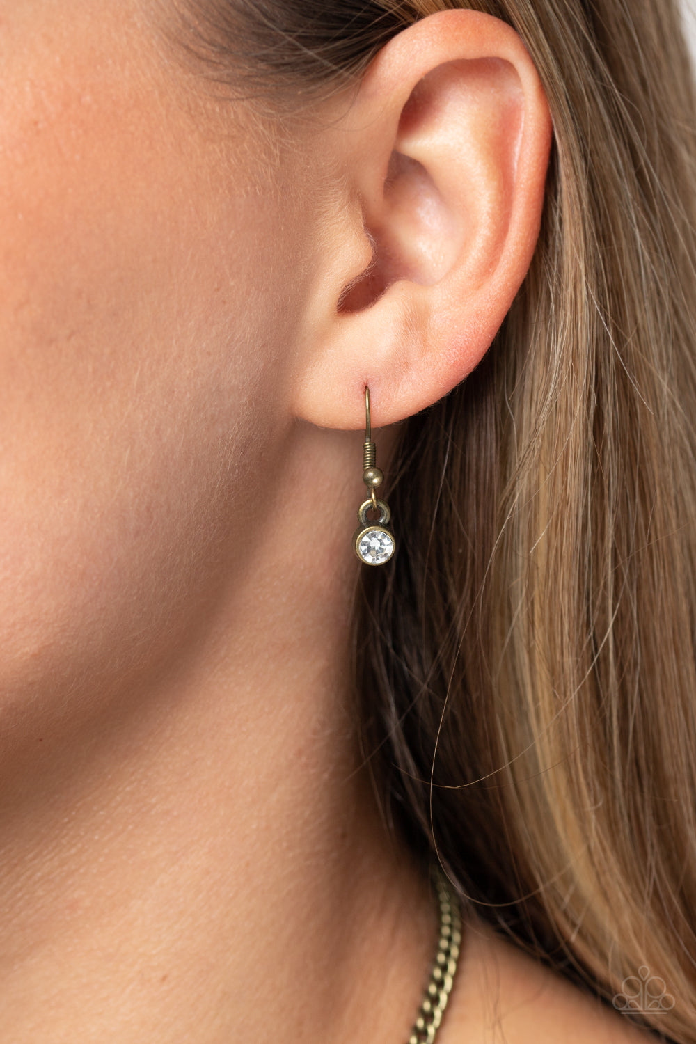 Paparazzi Accessories Shimmering Song - Brass Shimmery strands of white rhinestones in varying sizes majestically morph into brass-framed layers along the collar for a sparkling statement piece. Features an adjustable clasp closure. Sold as one individual