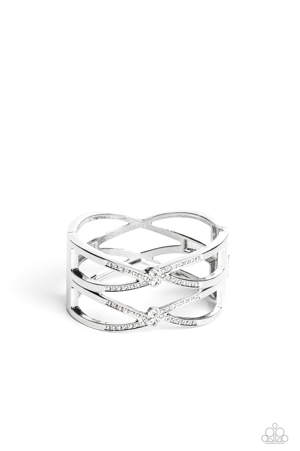 Paparazzi Accessories Entrancing Etiquette - White High-sheen silver bars airily weaves around the wrist in a zig-zag manner into a refined statement. Featured on the crossed ribbons of the silver, rows of dainty white rhinestones cluster across the displ